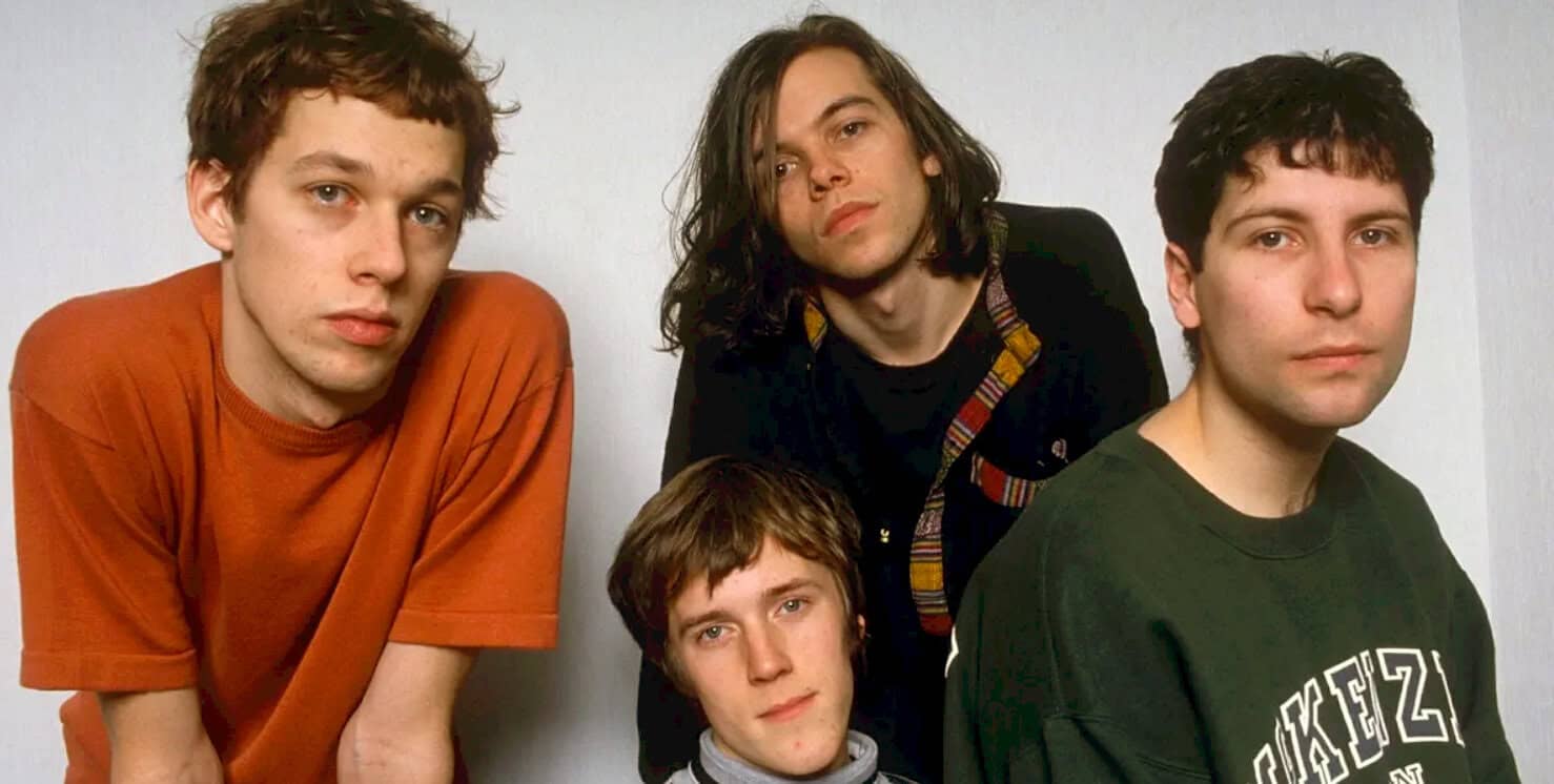 Teenage band members portrait, alternative rock musicians, 90s style grunge fashion, music history, indie music scene, music archive, past daily sound archive, musical nostalgia.