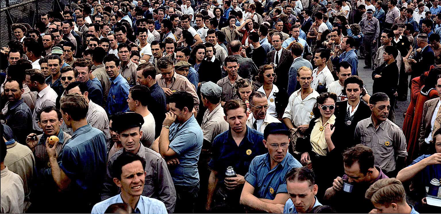 Crowd of people at a historical protest or rally, diverse group of men and women, vintage clothing styles, 1940s or 1950s era, social activism, public gathering, vintage photograph, historical event.