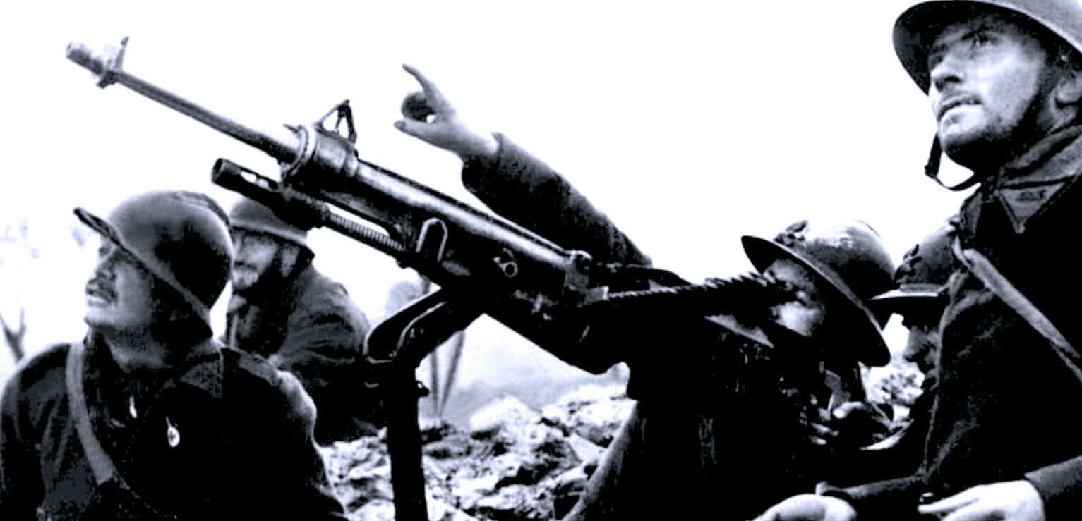 Gun with soldiers in combat, military war scene, world war II combat footage, historic war photograph, past daily news archive image.