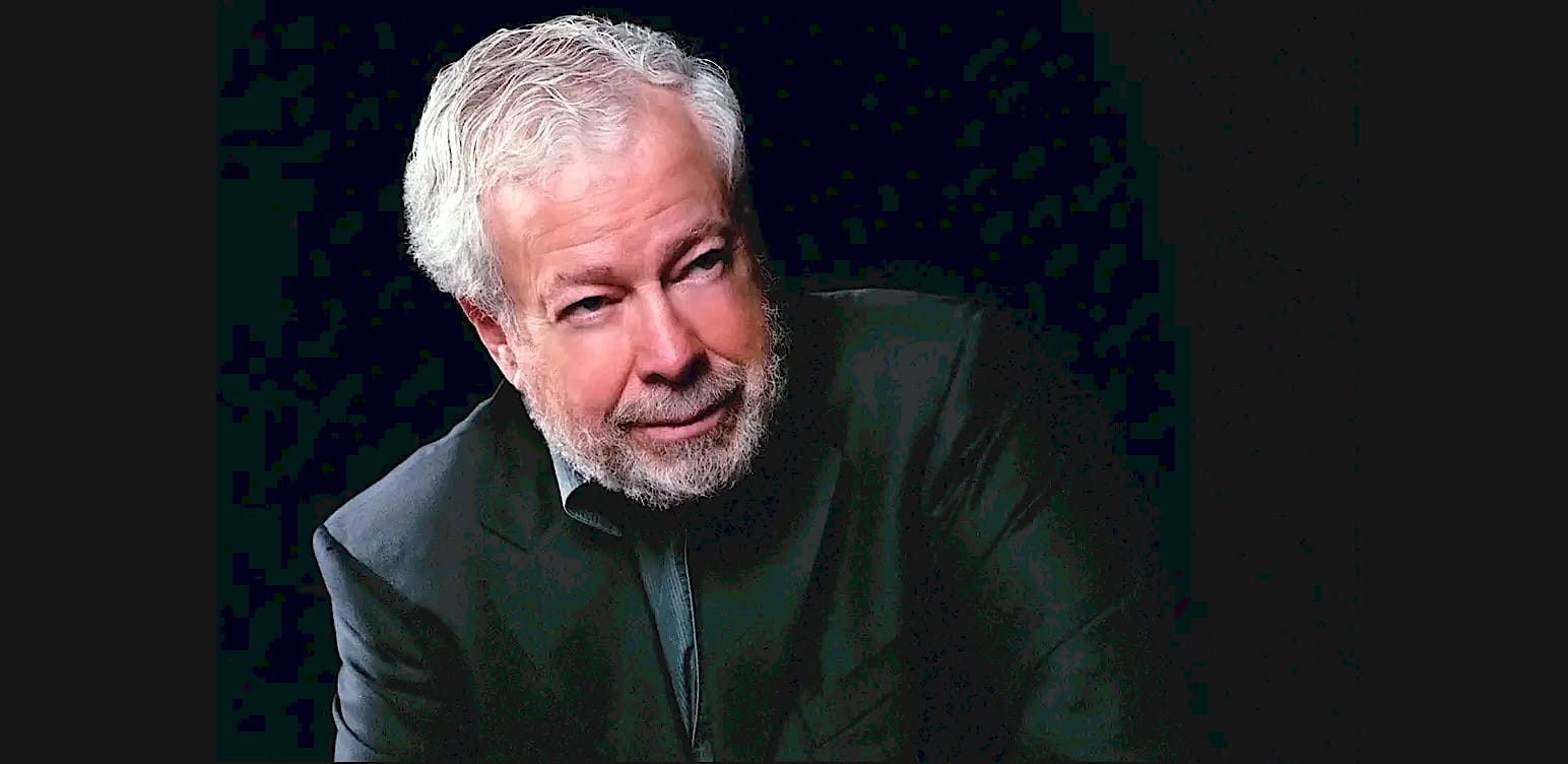 Innovative older man with white hair and beard in formal black attire, close-up portrait for news, history, music archive, Past Daily, sound archive background, professional speaker or host in media.