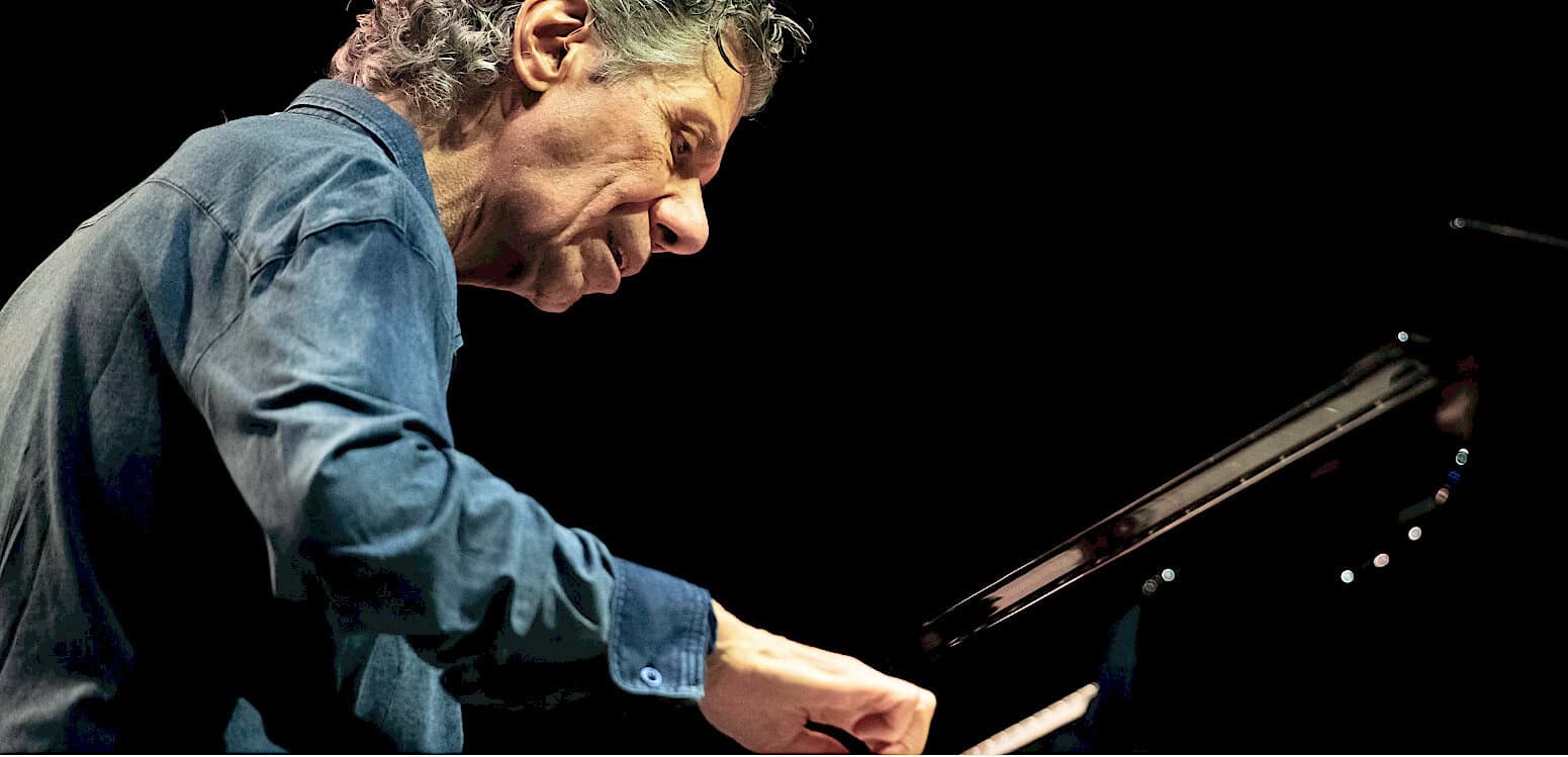 Close-up of a pianist playing a grand piano, showcasing passion in music performance, linked to historical news, sound archive, and music history concepts.