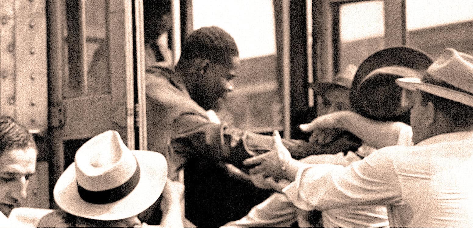 African American man being assisted off a bus by a woman and a man in a cowboy hat, depicting a historic civil rights moment with themes of racial integration and social change.