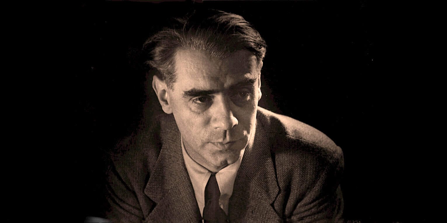 Vintage black and white portrait of a serious man in 1950s attire, emphasizing classic film noir style, suitable for themes of history, news archives, or vintage music and entertainment.