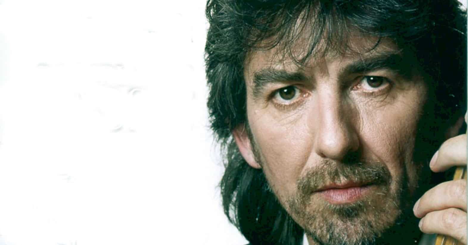 Vintage photo of a man with long dark hair and a beard, holding a telephone receiver, representing classic music and news stories from the Past Daily sound archive.