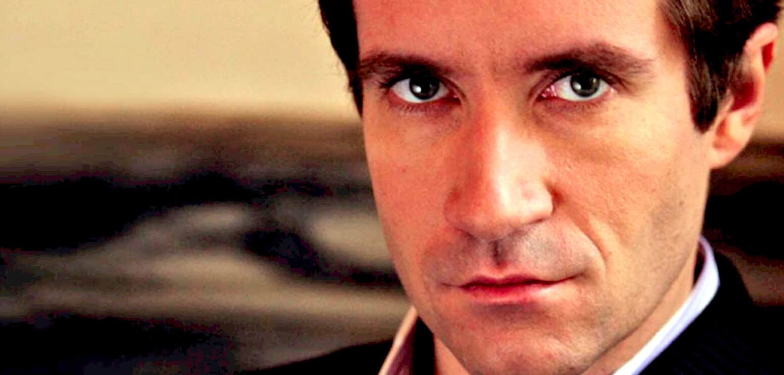 Close-up of a young man with blue eyes, dark hair, and fair skin, emphasizing facial features in a professional setting, highlighting the importance of historical news archives and music documentation.