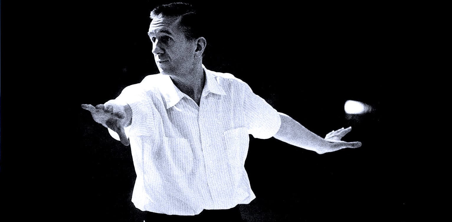 Vintage black and white photo of a radio announcer or musician with arms outstretched, highlighting historical news, music, and media coverage from the Past Daily archive.