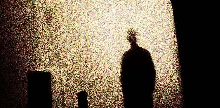 Shadowy silhouette of a person standing against a textured background, evoking themes of history, news archives, and music recordings central to Past Daily's sound archive collection.
