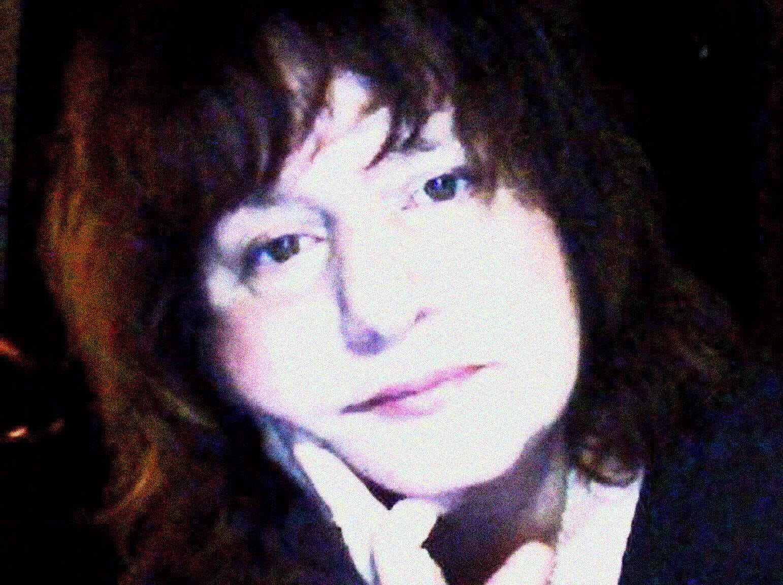 A vintage photograph of a woman with dark curly hair, reflecting the nostalgic theme of Past Daily's sound archive of news, history, and music.