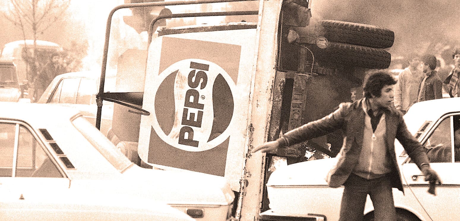 Pepsi truck and street scene from a historical event, capturing vintage transportation and urban life.