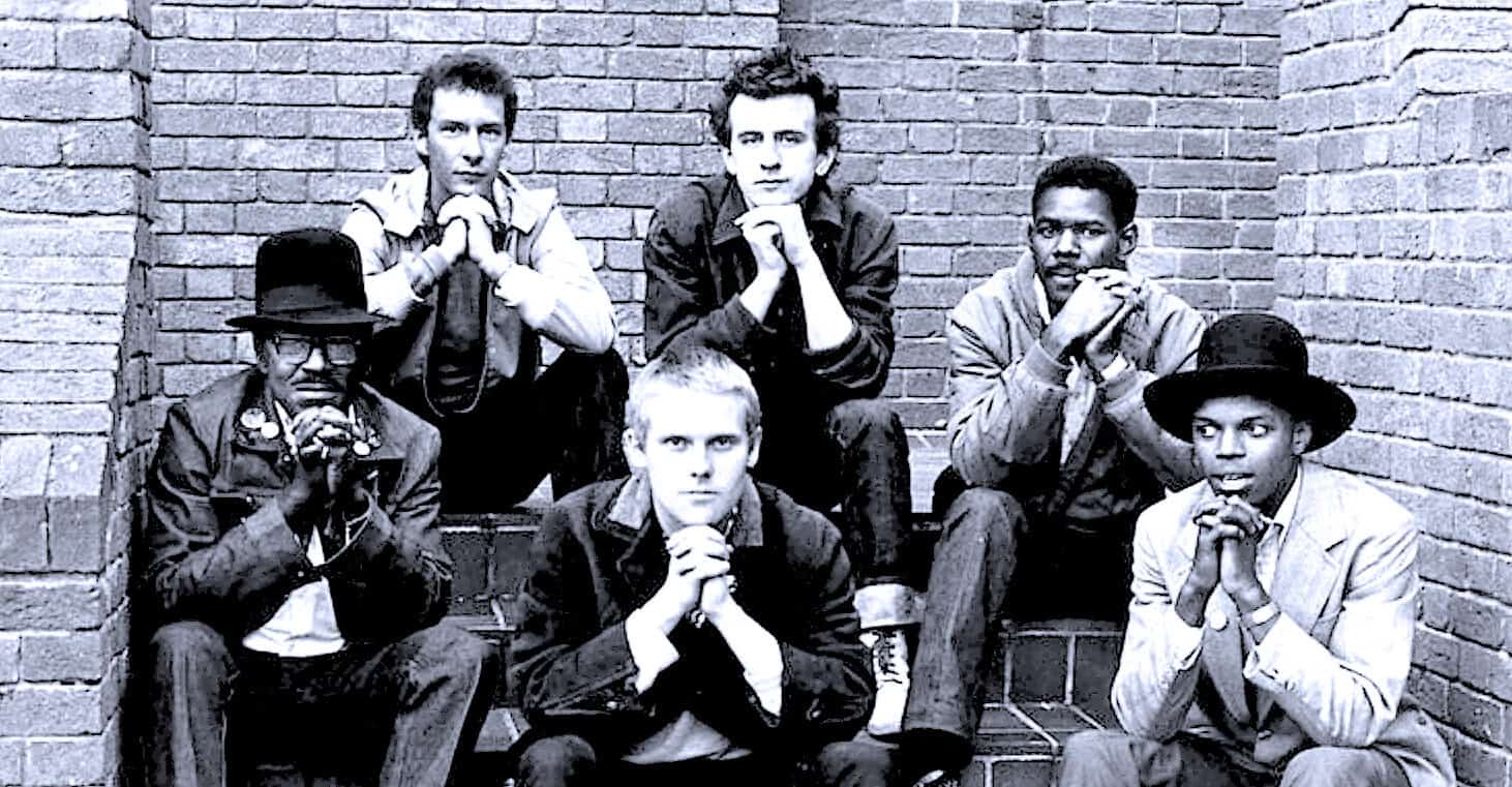 Soul Asylum band members sitting on brick stairs, promoting 1990s alternative rock music, part of music history archives, featured in Past Daily's sound archive collection.