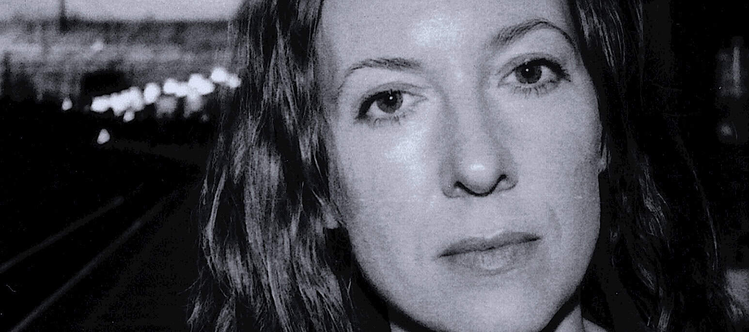 Harboring hopes, a woman with wet hair looks into the camera with a contemplative expression in a black and white photo, emphasizing emotion and introspection, suitable for vintage news and history archives.