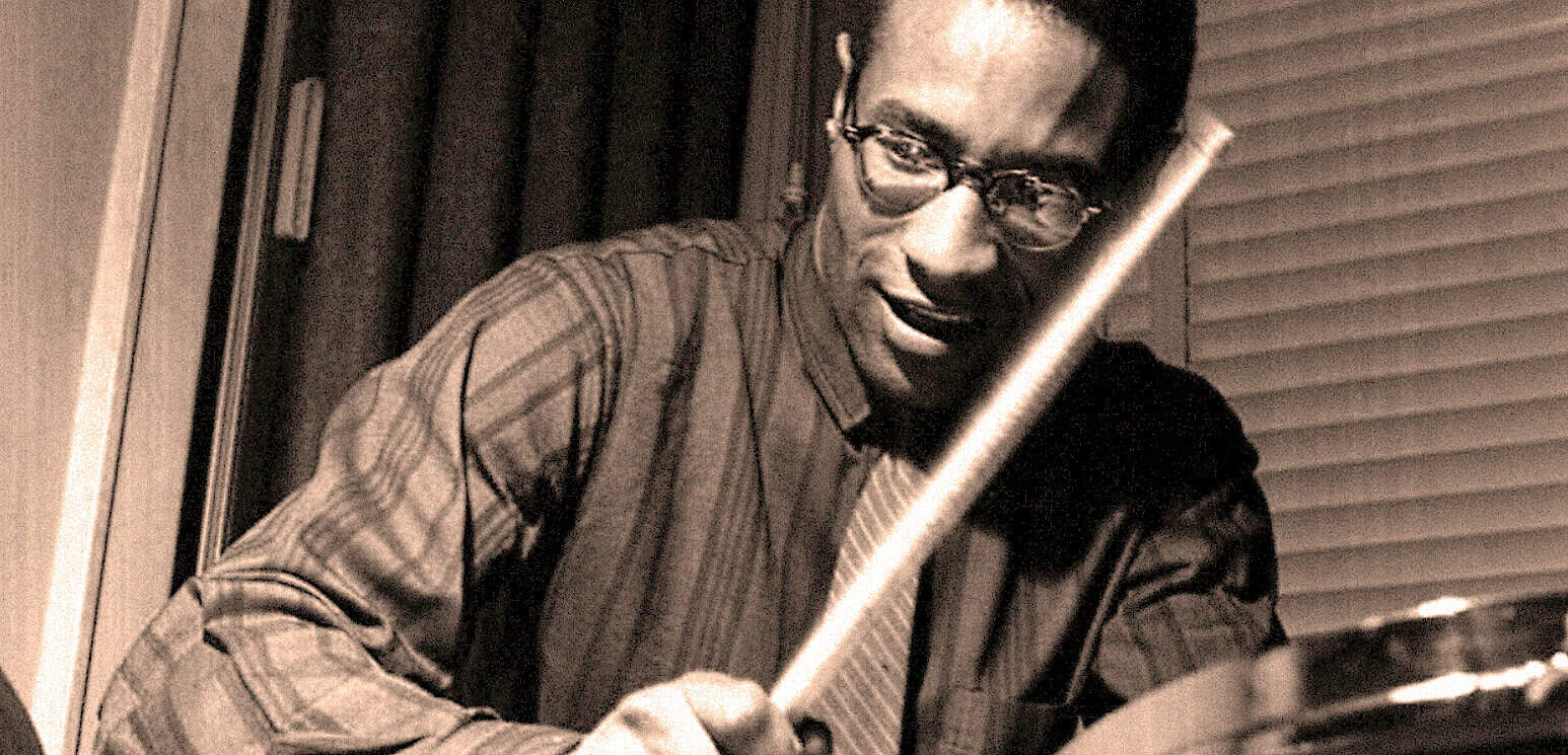 Past-daily-news-music-history-archive-black-man-reading-music-score-archival-recordings.