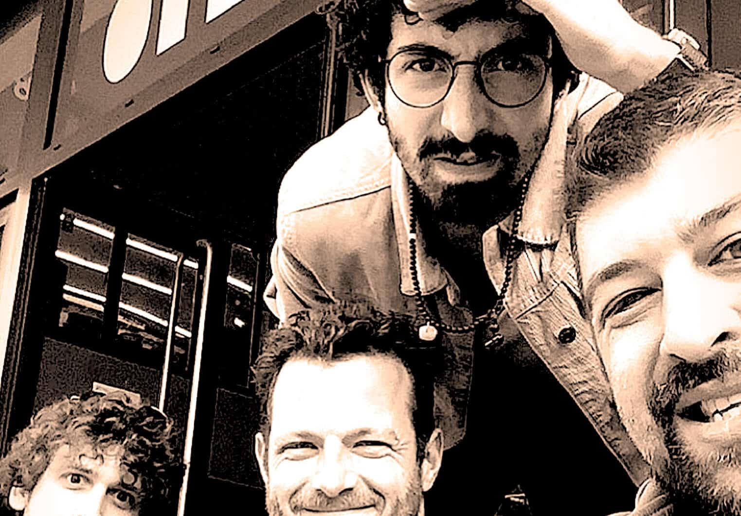 A group of diverse friends taking a selfie together at a lively social gathering, capturing joyful moments with music, news, and history themes, reflecting past daily memories and vibrant culture.