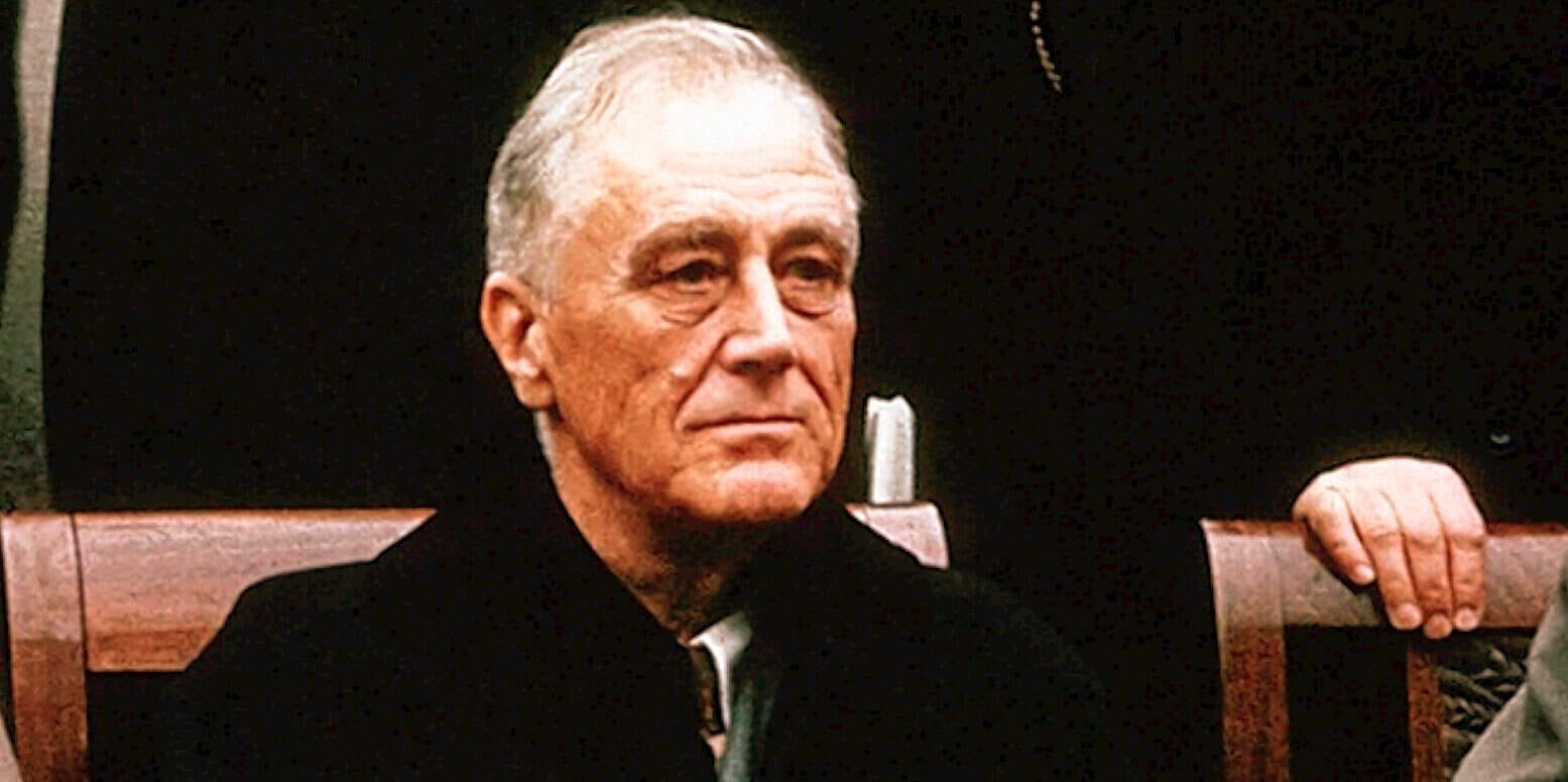 Senior man in formal attire at a news or history archive listening session, emphasizing vintage sound archives, historical interviews, and music preservation.