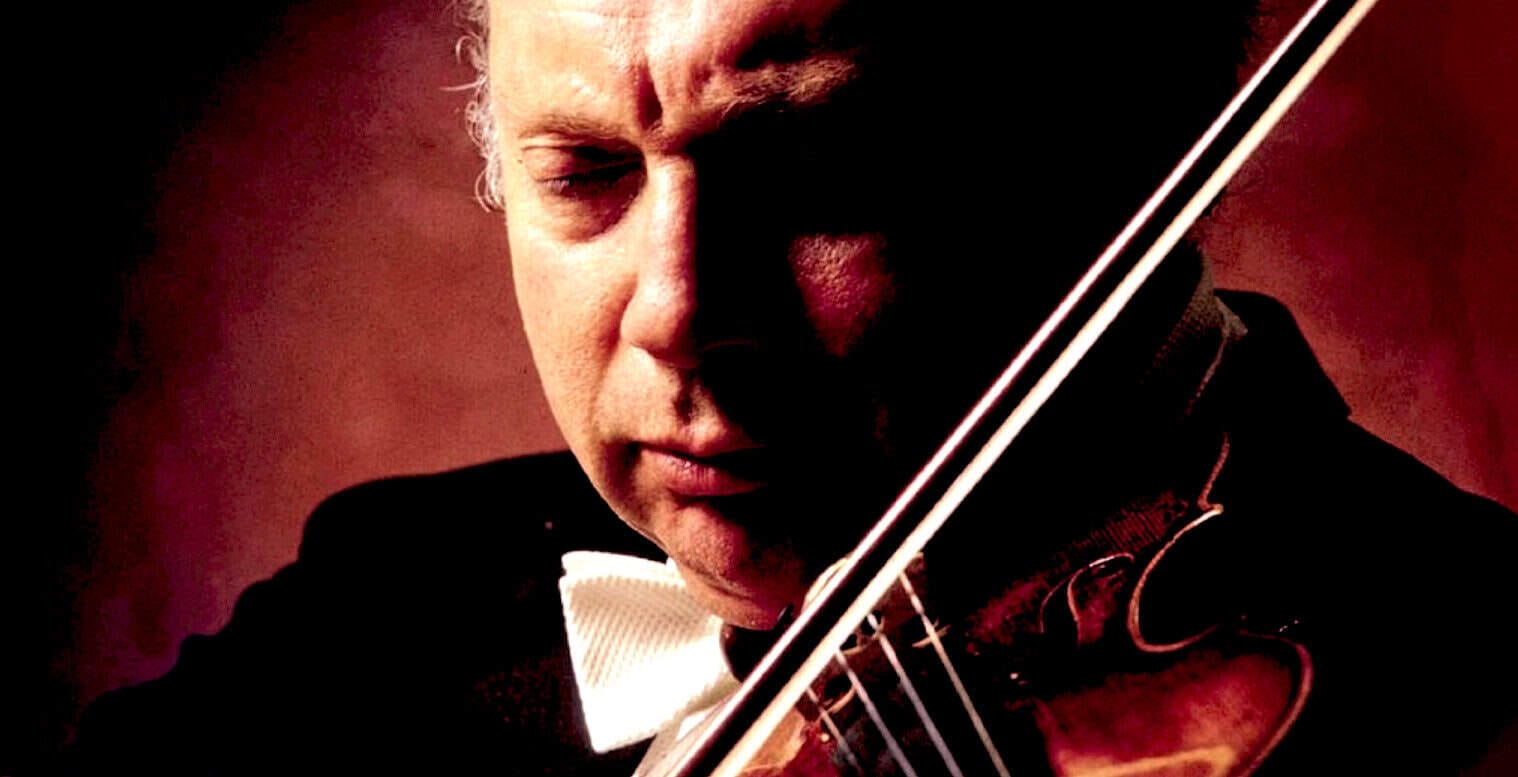 Violinist performing classical music, showcasing a sound archive of historical news and music at Past Daily.