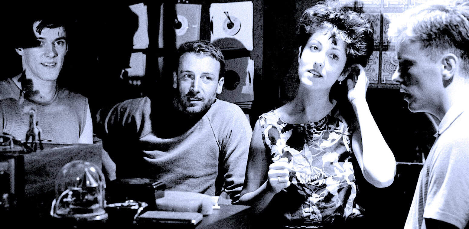 Vintage radio station recording session with people discussing news, history, and music for archive. Capturing moments of conversation and cultural exchange in a black-and-white photo.