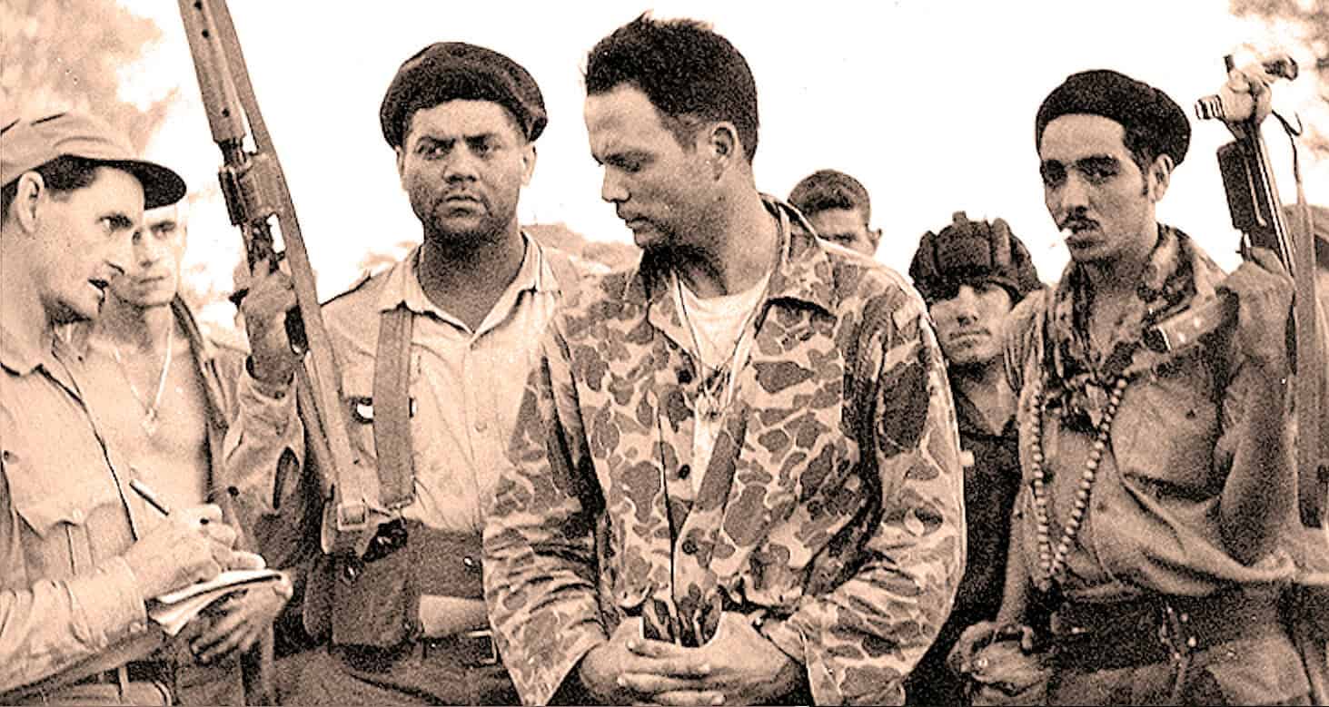 Soldiers in military gear having a discussion during a historical conflict, capturing moments of war, peace negotiations, and military history for archival purposes.