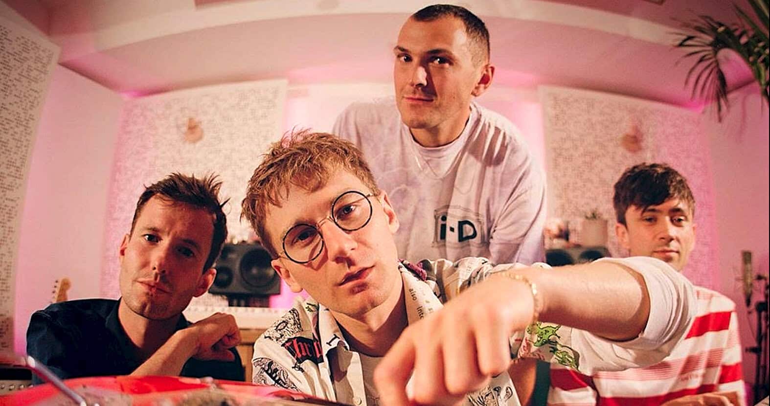 I-D magazine music and pop culture influencers photo, young stylish men in a vibrant studio, representing creative music scene and contemporary pop culture, reaching a broad audience interested in modern trends and entertainment.