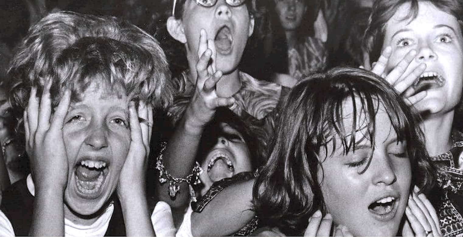 A black and white photo of shocked children with wide eyes and open mouths, capturing a moment of intense emotion or surprise, exemplifying news and historical moments in a sound archive; reflects childhood reactions and media history.