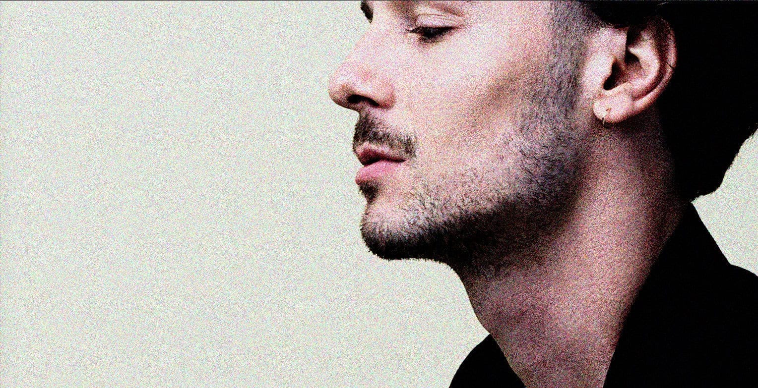 Man with hat and earring in profile, promoting past daily sound archive of news, history, and music for audio preservation and historical research.