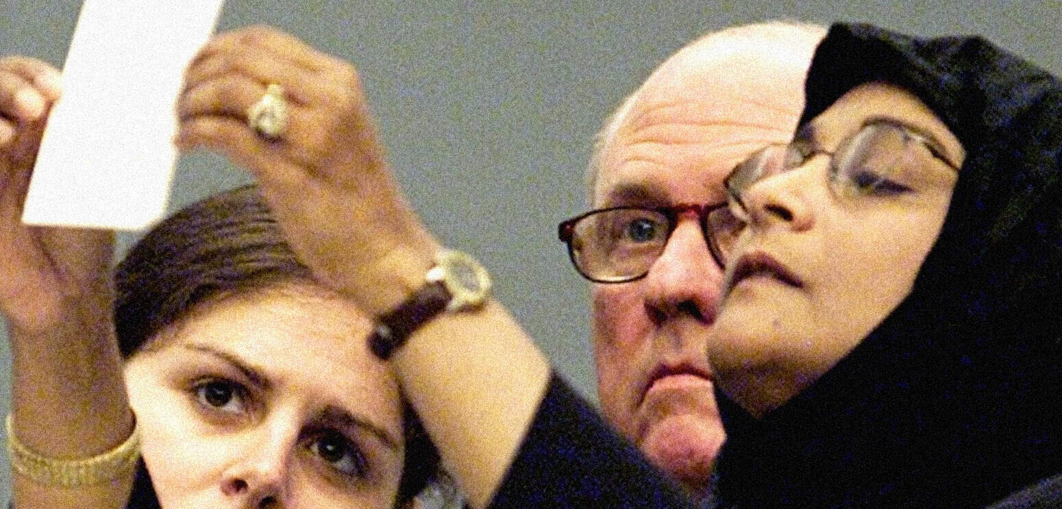 Archival news event with two individuals examining documents, representing rich history and media archives.