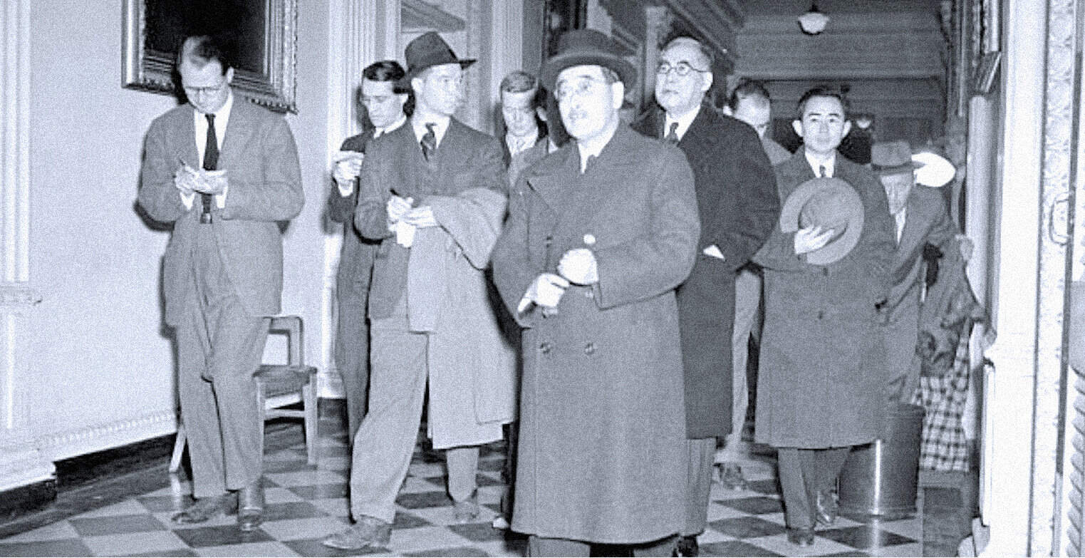 People in history walking through a hallway, vintage black-and-white photo, historical figures, 20th-century attire, archive of historical moments, news and media history, past daily sound archive, vintage news reporters, historical news event, historical photo archive relevance.