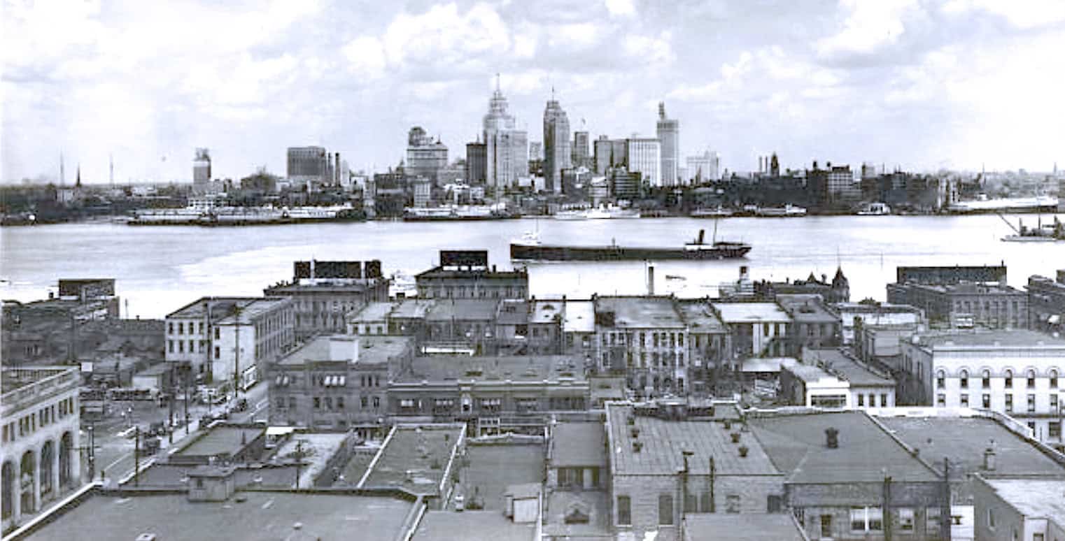 City skyline with historic buildings and waterfront view, vintage black and white photo of urban architecture, music and news archive imagery, Past Daily historic sound archive, cityscape and historical records, audio history and news legacy platform.