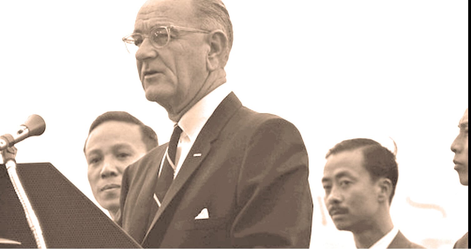 Vintage news archive photo of political leader speaking at a press conference or event, historical news and media coverage, nostalgia for past news history and music, Past Daily archive image in sepia tone.