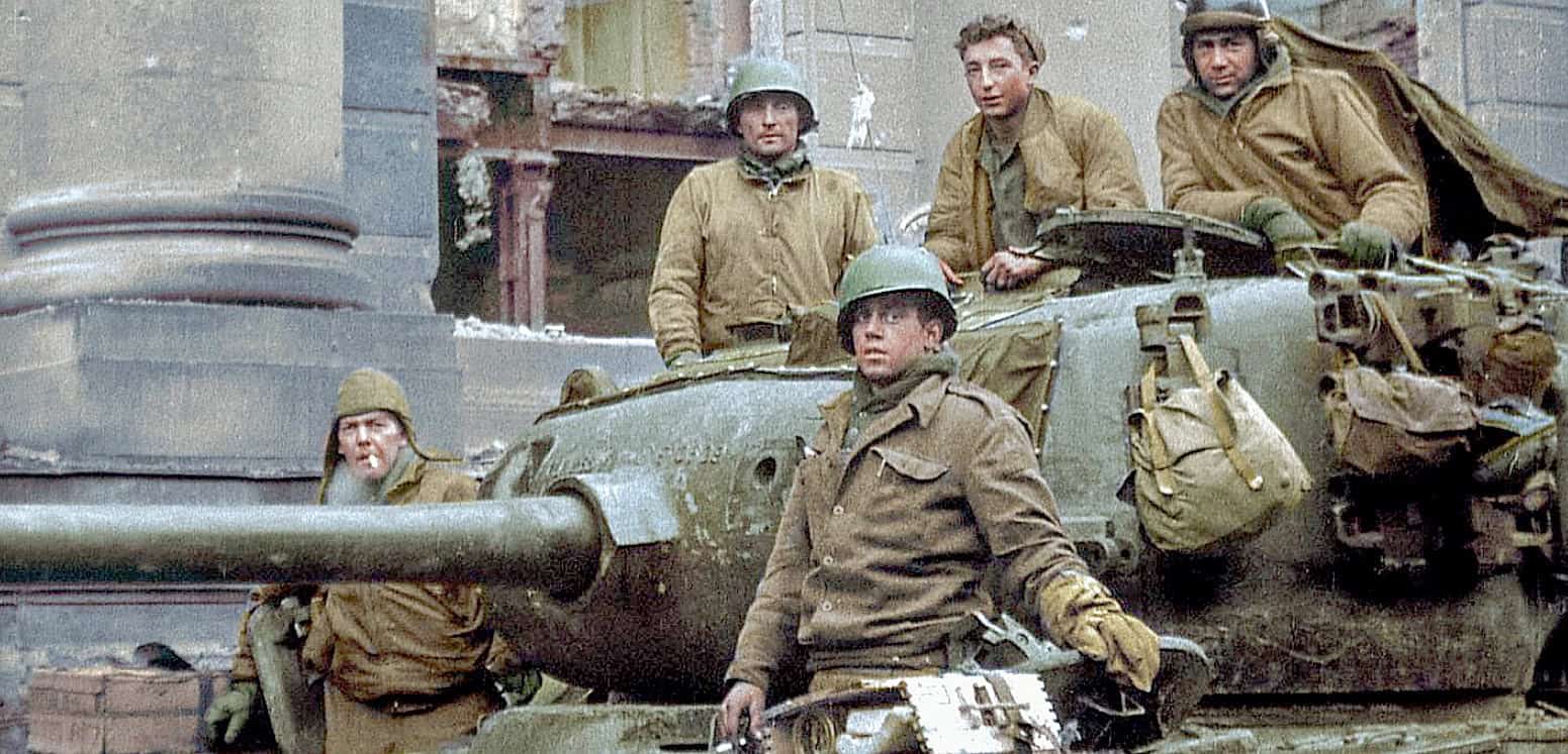 World War II soldiers on a battlefield with military vehicles, historic war scene, military history, WWII, armed forces, combat gear, war surroundings, and army operations.