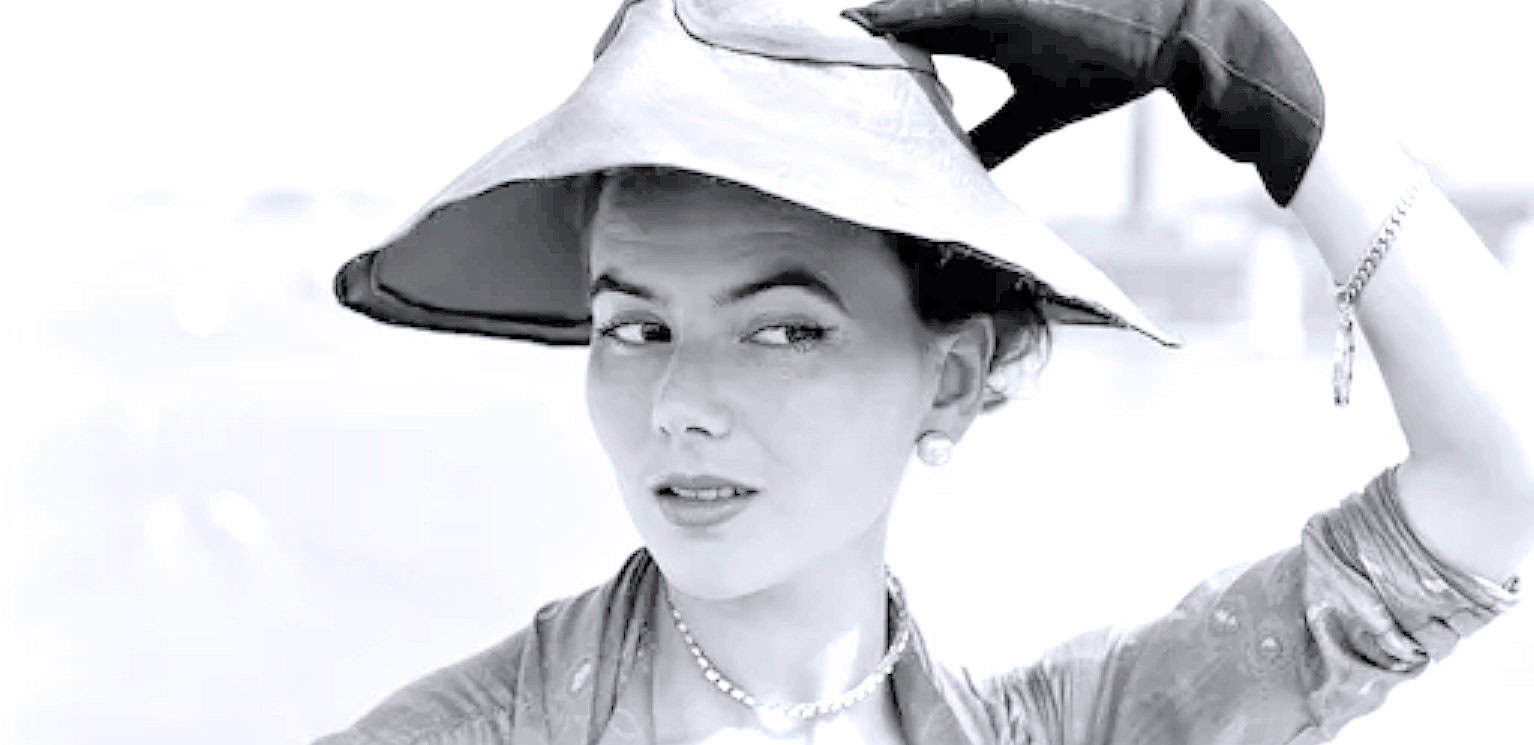 Vintage black-and-white portrait of a woman wearing a large hat, showcasing classic fashion style. Perfect for historical news, fashion history, and iconic style archives.