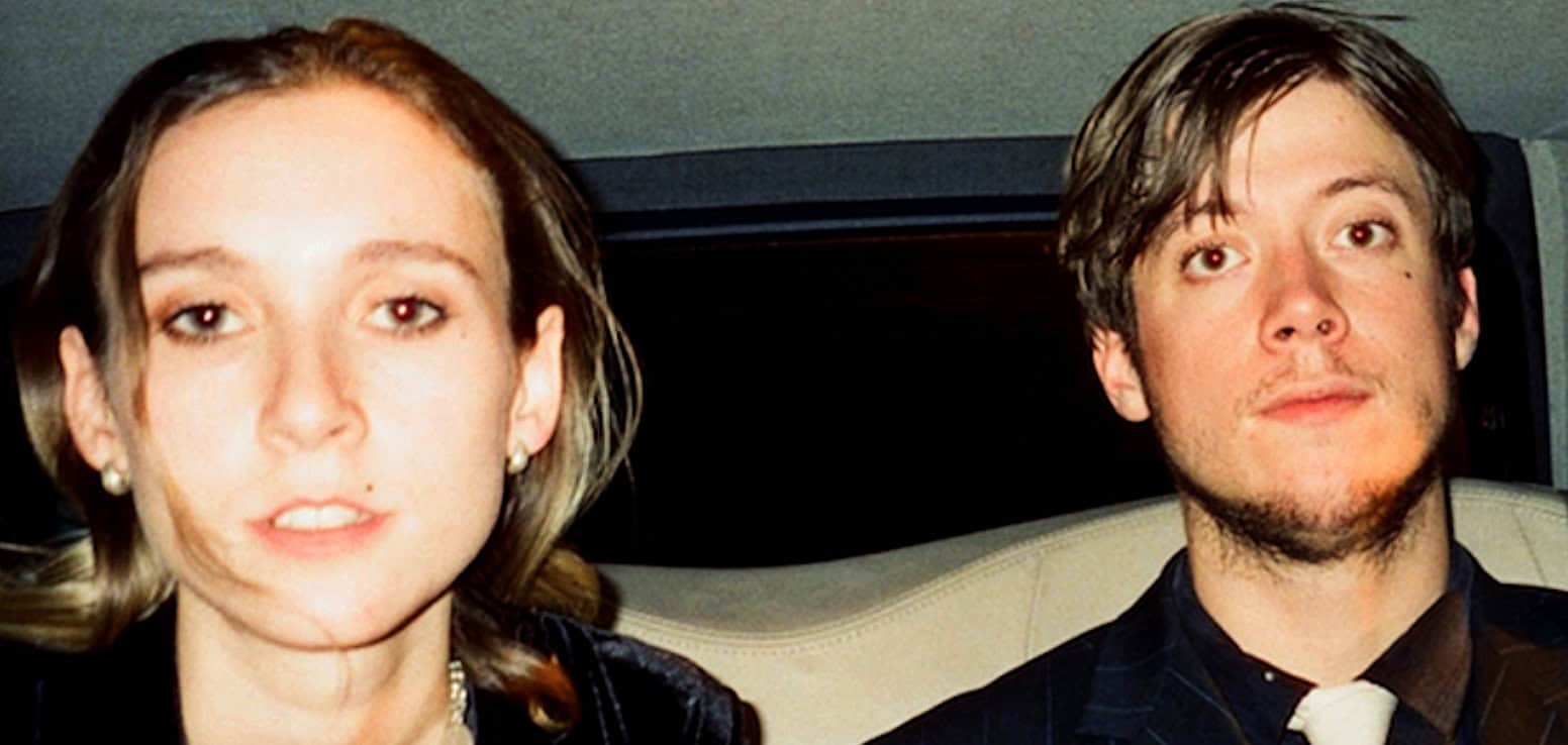 A woman and a man dressed in formal attire, likely at a news or music event, highlighting Past Daily's focus on news archives, history, and music preservation.