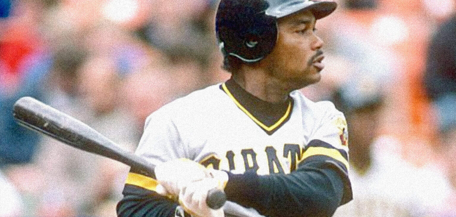 A baseball player in a San Diego Padres uniform, holding a bat during a game, with a blurred audience in the background.