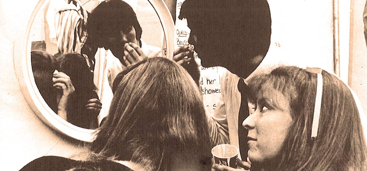 Sewing vanity mirror reflection photo of young women hairstyling and makeup classic vintage style news history music archive.