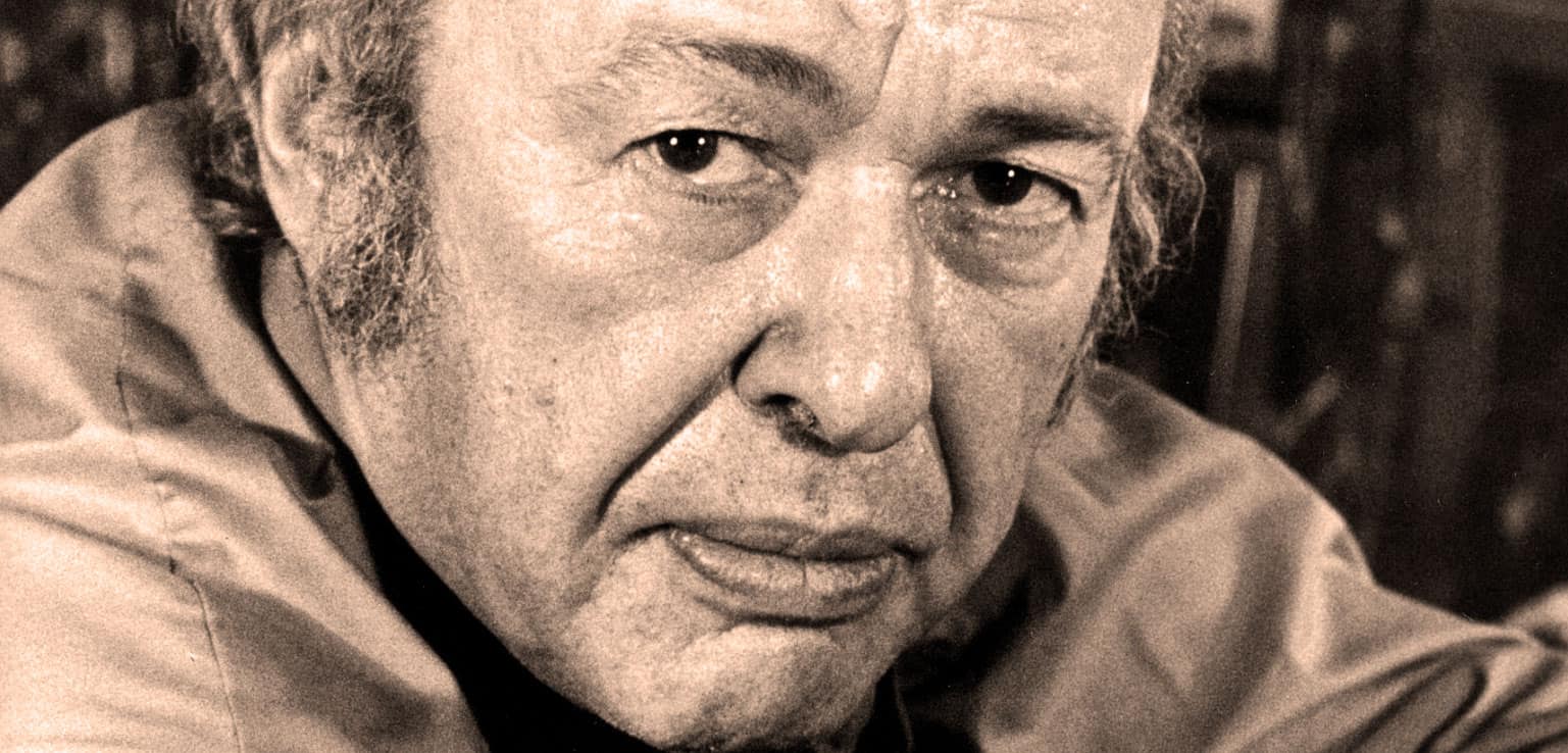 Portrait of a man with textured skin and intense gaze, black and white photography, historical figure, classic documentary style, past daily archive focused on news, history, and music.