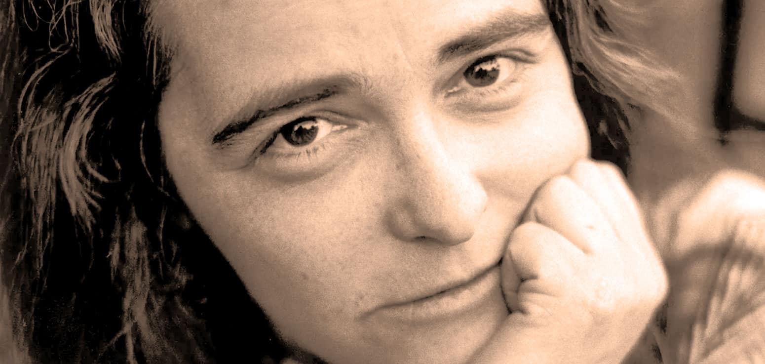 Close-up of a young woman's face, smiling softly, representing nostalgia and history, featured on Past Daily’s sound archive of news, music, and historical recordings.