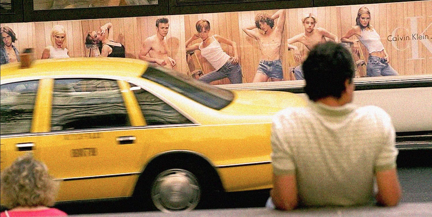 Yellow taxi cab in front of a mural featuring women in casual fashion at Calvin Klein.
