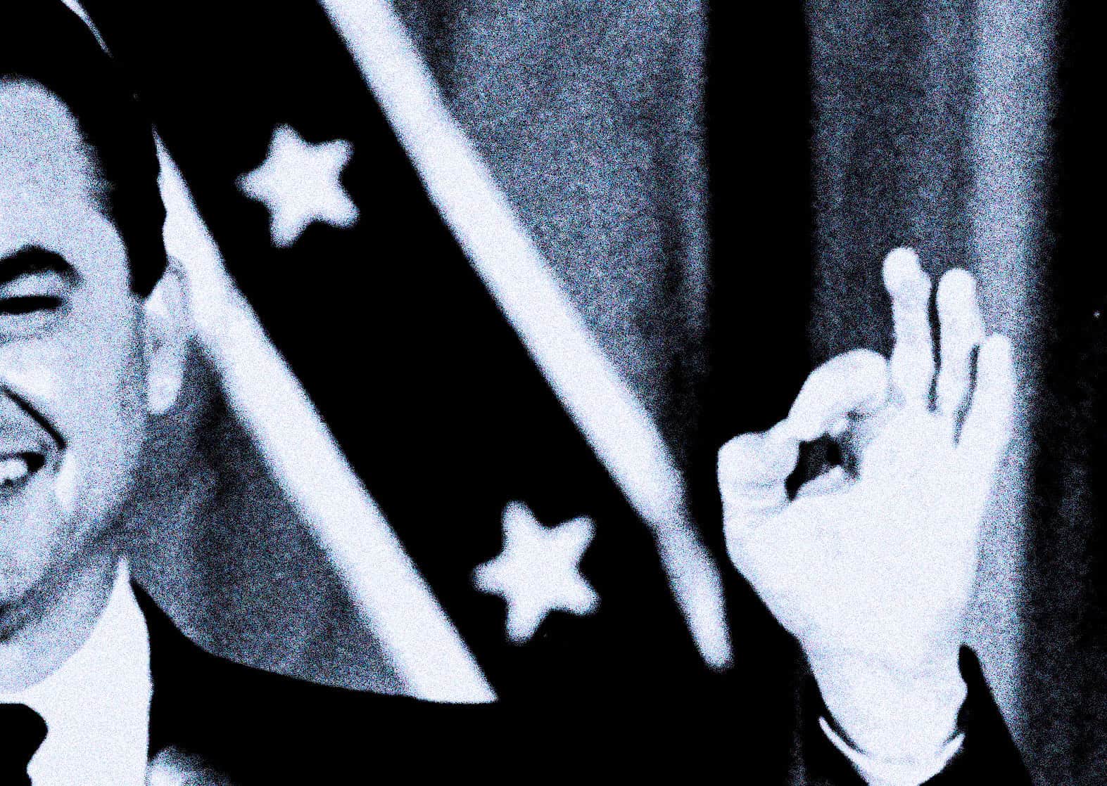 Vintage black and white image of a person holding a small American flag, representing news, history, and music archives. Iconic photo capturing patriotic themes and cultural heritage.