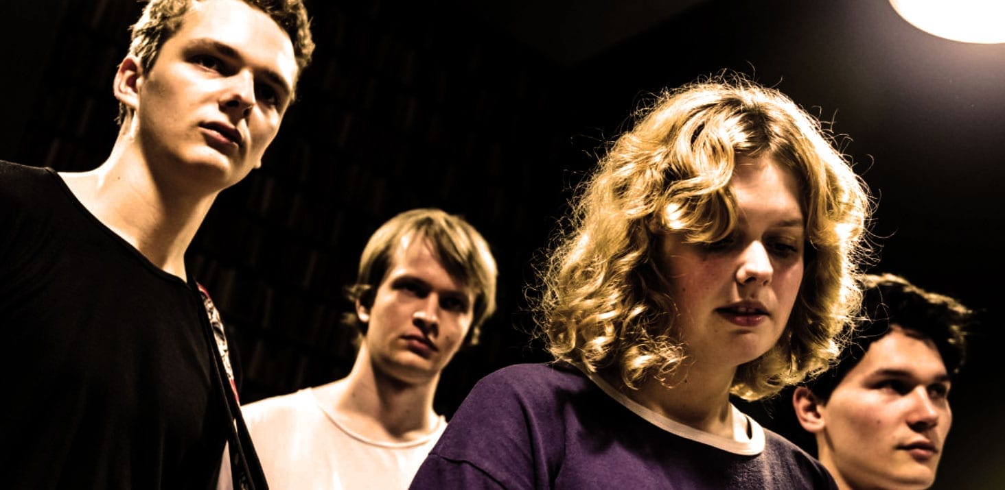 Young indie band members during a rehearsal or performance, capturing the essence of music, youth culture, and artistic expression; perfect image for music history archives.