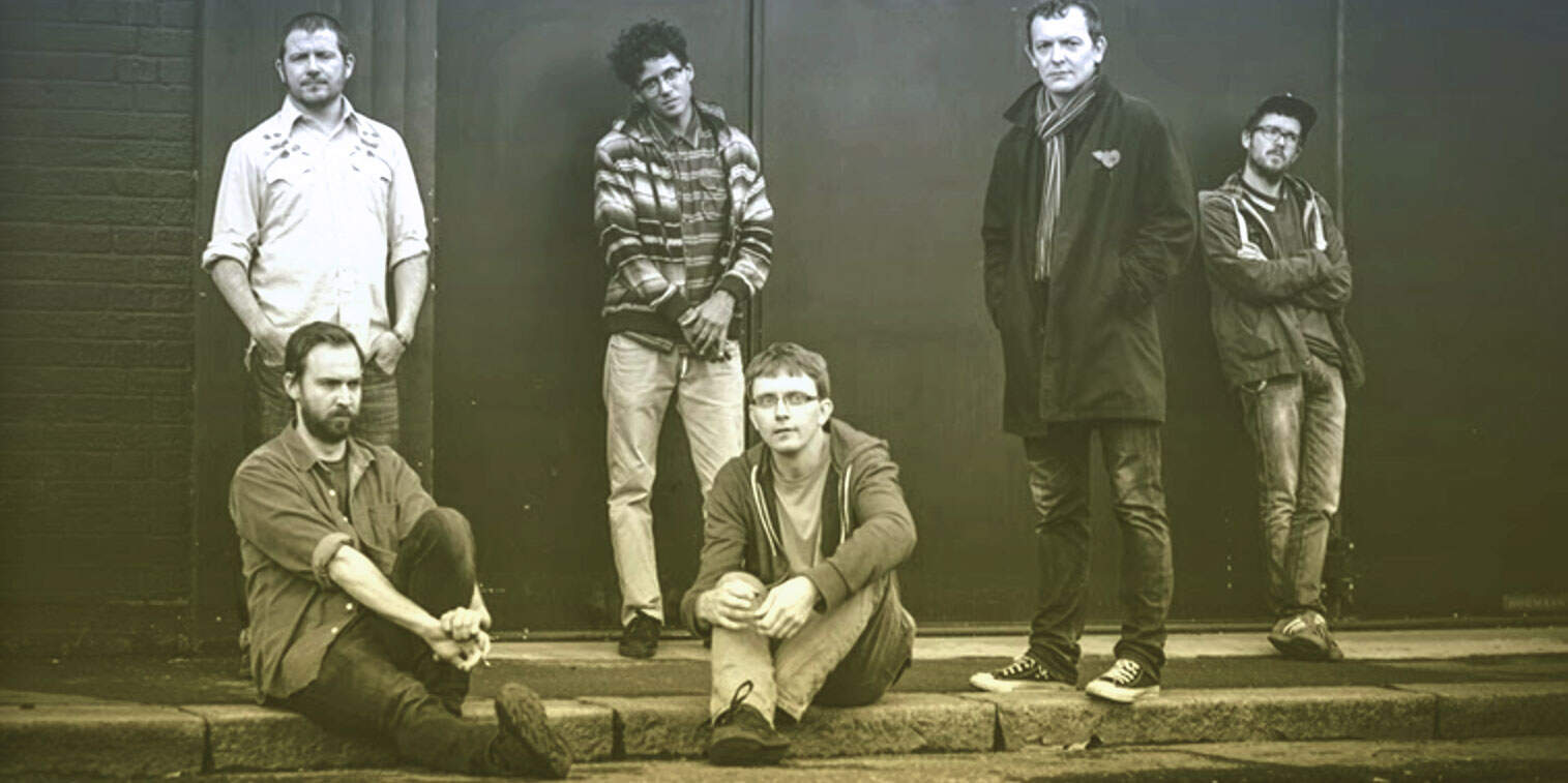 Vintage band members posing outdoors, showcasing music, history, and cultural archives, highlighting past daily news, sound recordings, and musical history, perfect for a sound archive website.