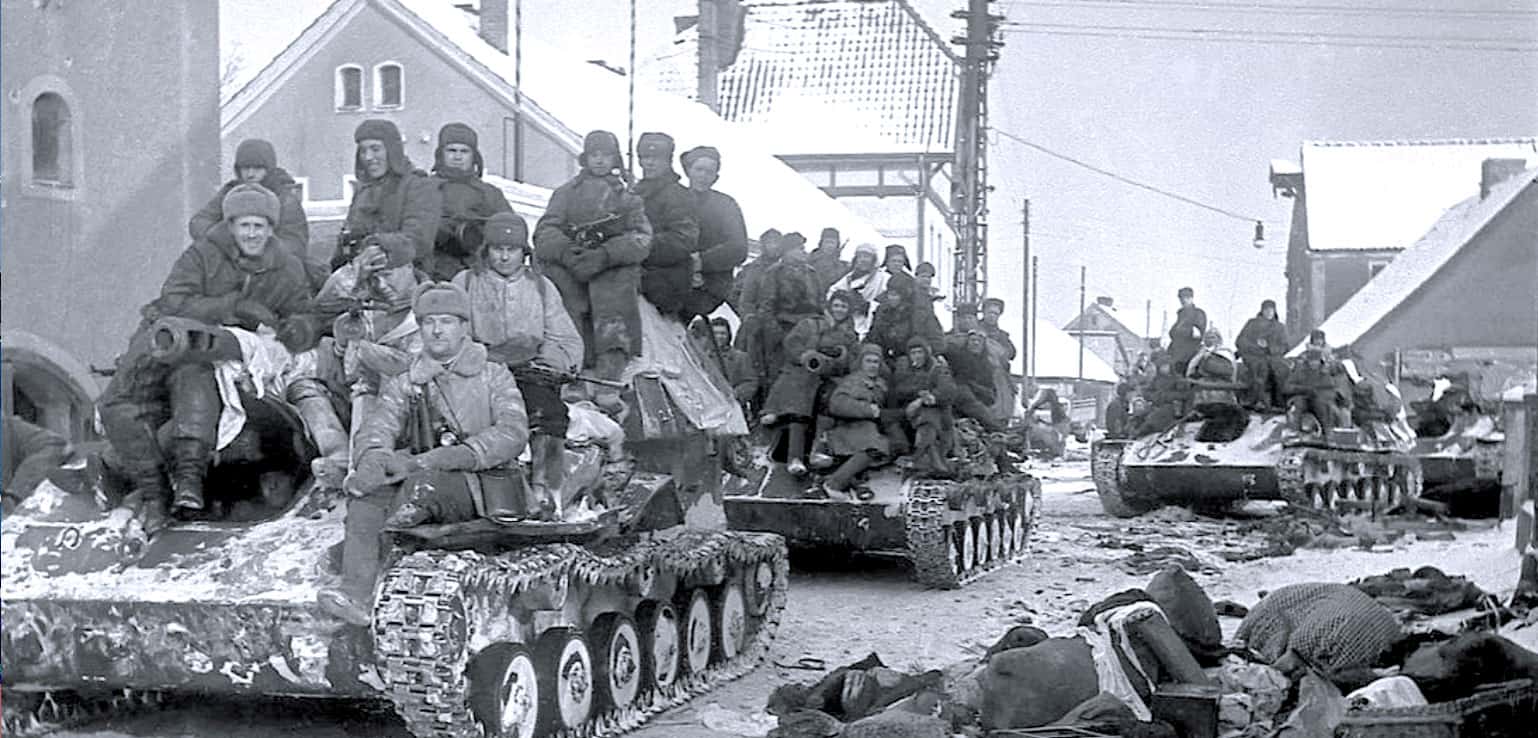 U.S. soldiers on tanks during World War II in a European town, wartime scene, historic military conflict, vintage black and white wartime photograph, soldiers in coat and helmets with tanks and destroyed debris.
