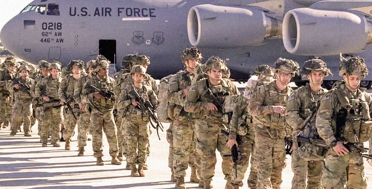U.S. Air Force soldiers marching in formation beside a military cargo plane, showcasing military personnel, aviation, and defense operations.