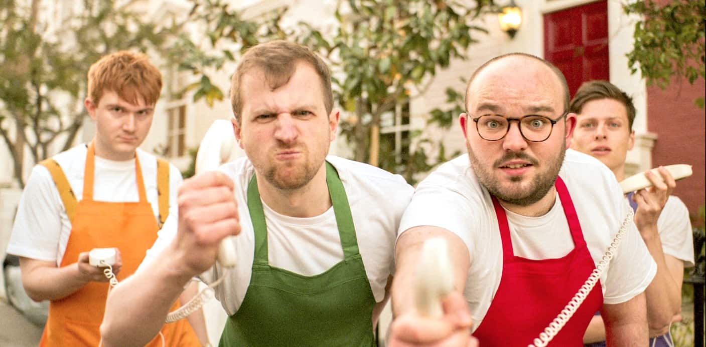 People protesting with vintage telephones wearing aprons, outdoor setting, humorous expression, activism, social issue, the 1960s.