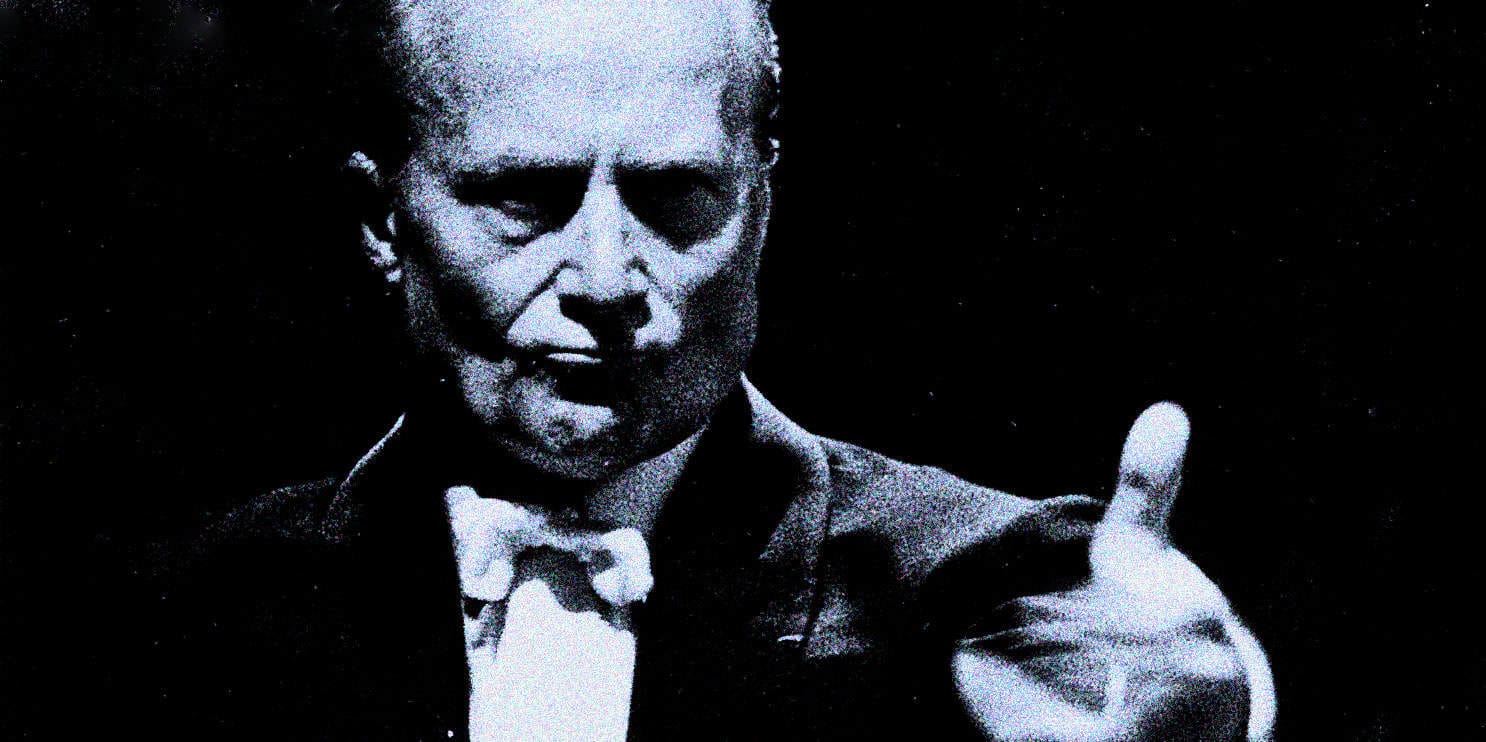 Historical black and white image of an elderly man with a serious expression, dressed in formal attire, possibly related to news, history, or music archives.