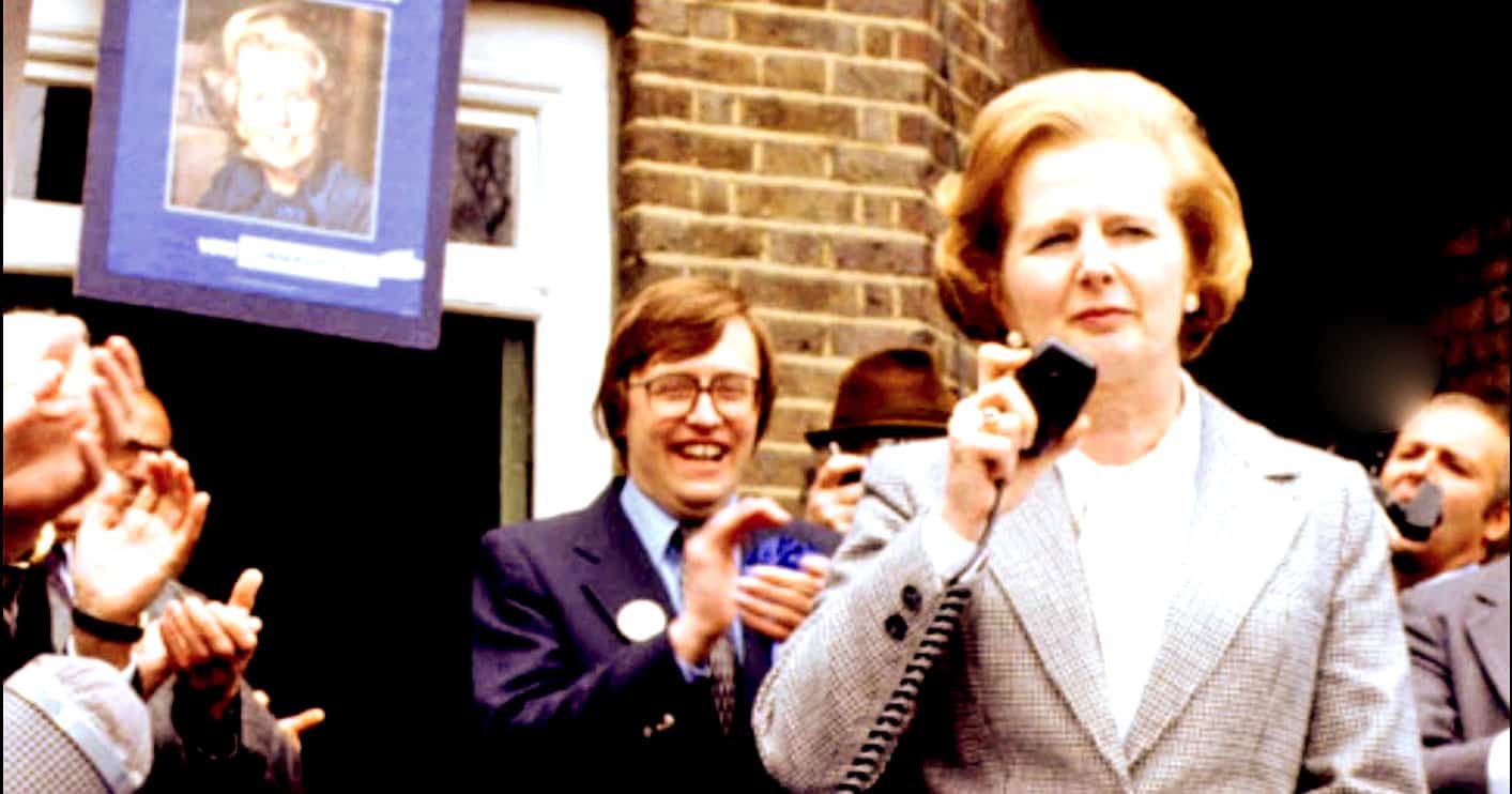 News event featuring Margaret Thatcher speaking on a vintage telephone during a public gathering or celebration.