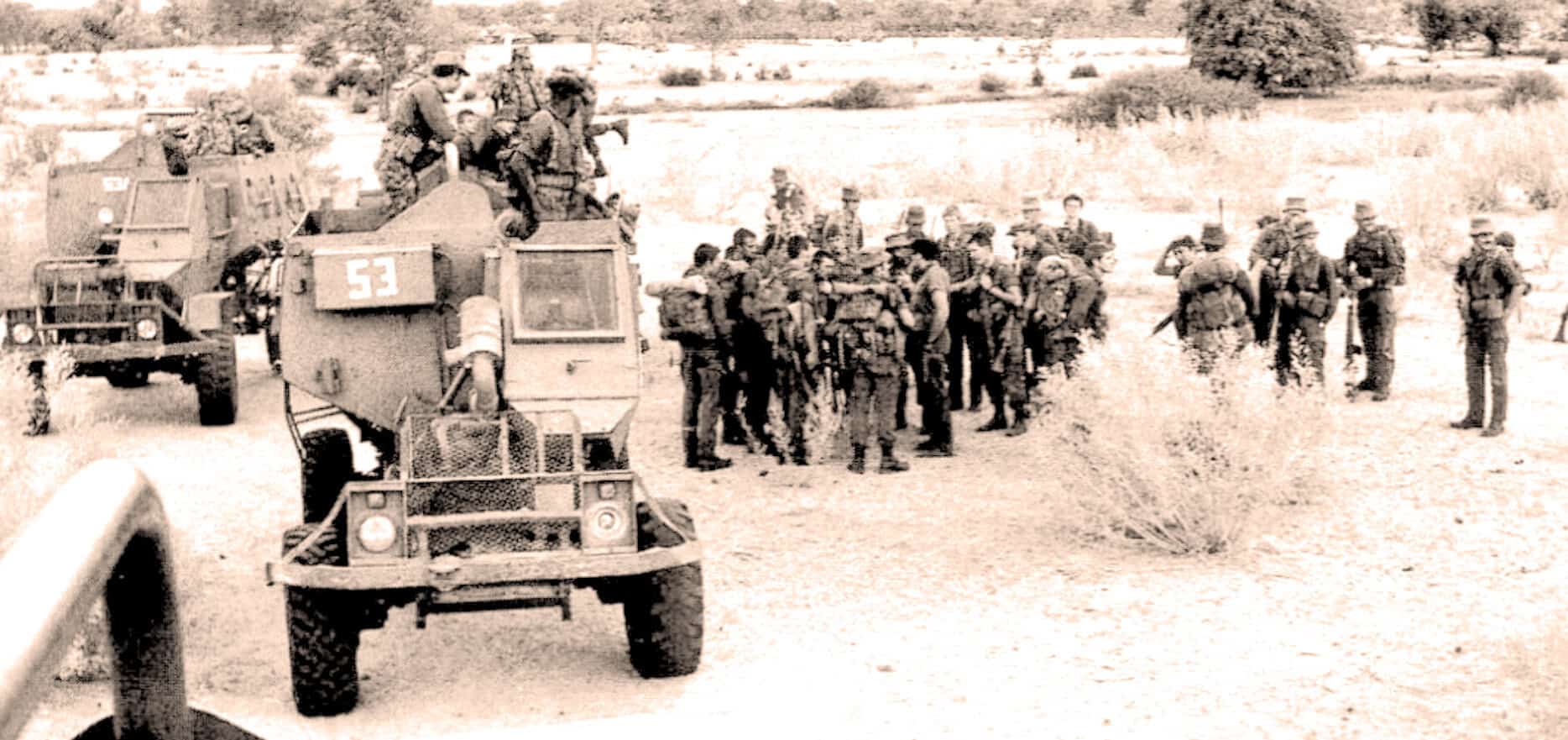 Soldiers boarding military vehicles during wartime, historical black and white photo, soldiers with backpacks and helmets, military convoy in a rural setting, vintage war era, archive news, historical footage, classic wartime scene, historical news coverage, vintage military transport.