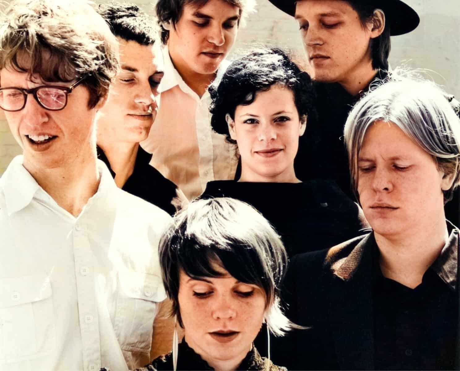 A diverse group of young people outdoors, listening to music with headphones and enjoying a moment of connection, capturing the spirit of community and cultural history for an online sound archive.