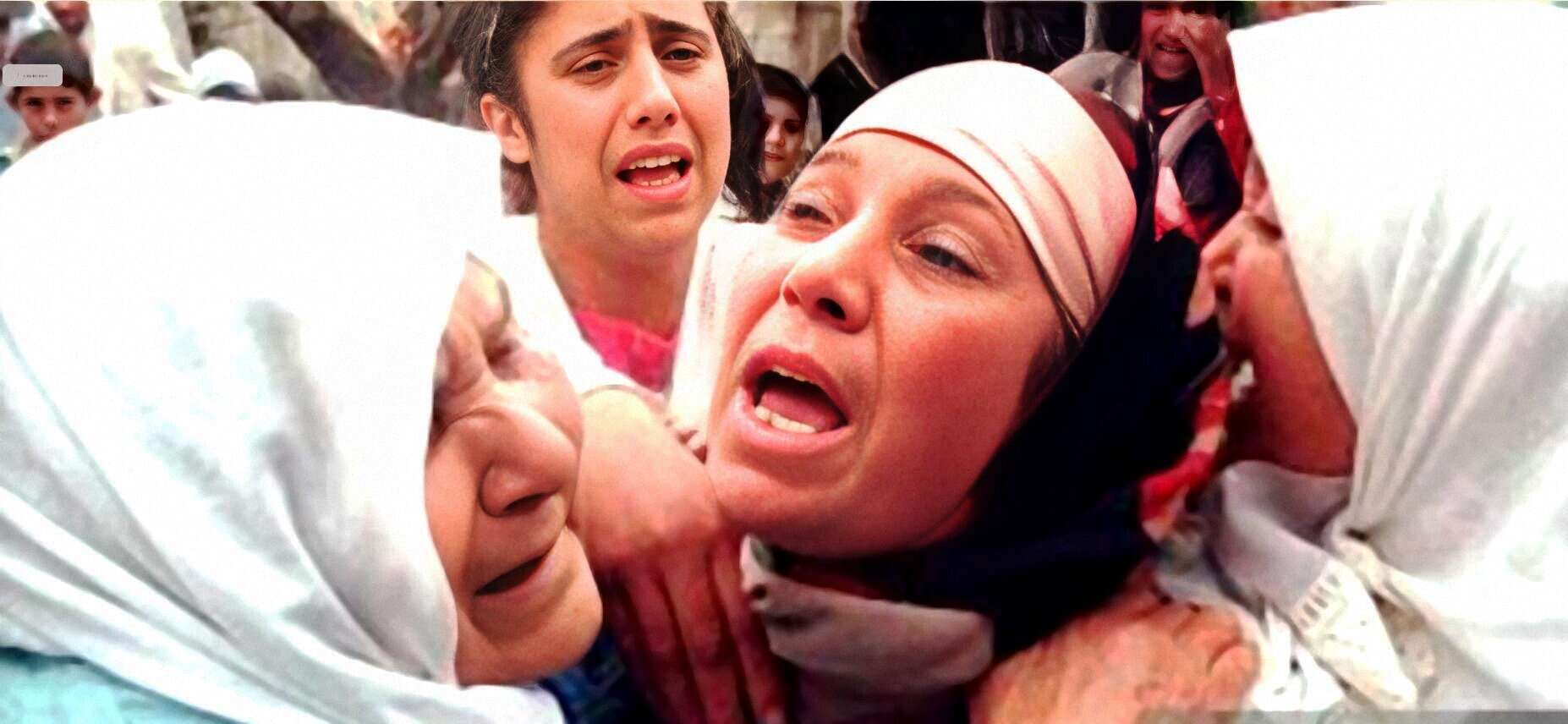 A distressed woman in medical attire being assisted by healthcare workers in an emergency situation, capturing a moment of urgent medical response and crisis.