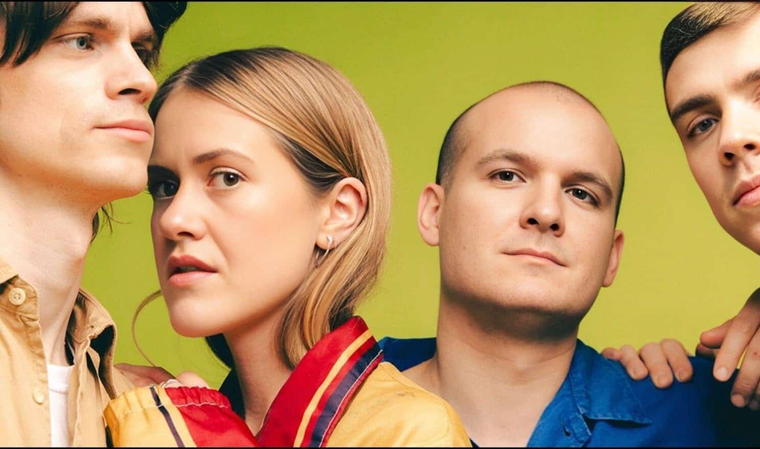 Vintage pop band members posing together with a green background, showcasing music history, 90s culture, and iconic musical artists for nostalgic appeal.