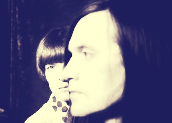 Vintage photograph of The Beatles, showcasing John Lennon and George Harrison, emblematic icons in music history and news archives, representing classic rock and cultural influence.