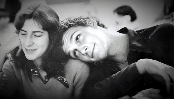 Vintage black and white photo of a young couple smiling and enjoying a moment together, capturing nostalgic feelings from the golden age of music, news, and history archive.